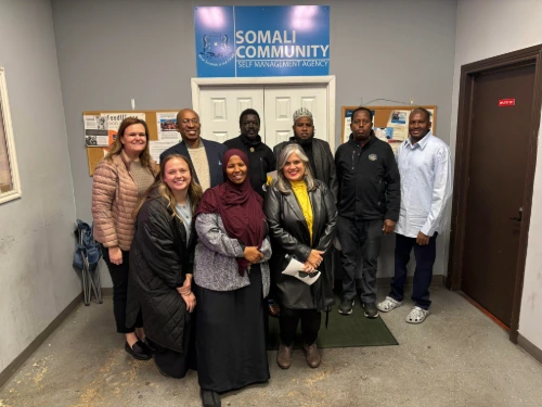 people standing in front of SOMCSMA office